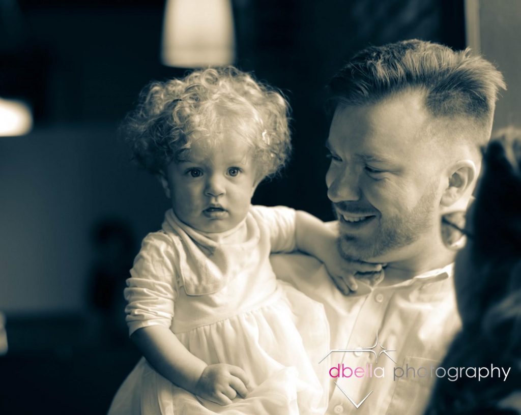 candid father and daughter at baptism