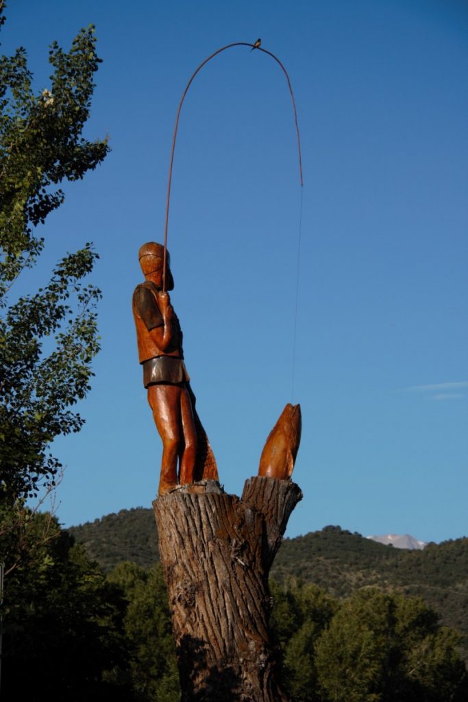 man caught trout statue